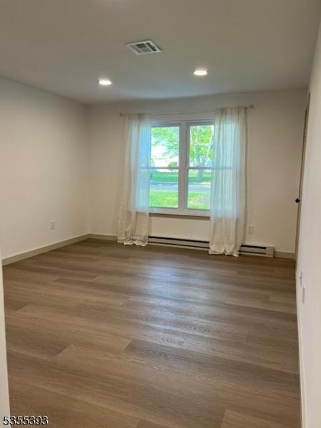 42B Catalpa Plz Unit B, Monroe Twp, NJ 08831 - empty room featuring recessed lighting, baseboards, wood finished floors, and baseboard heating