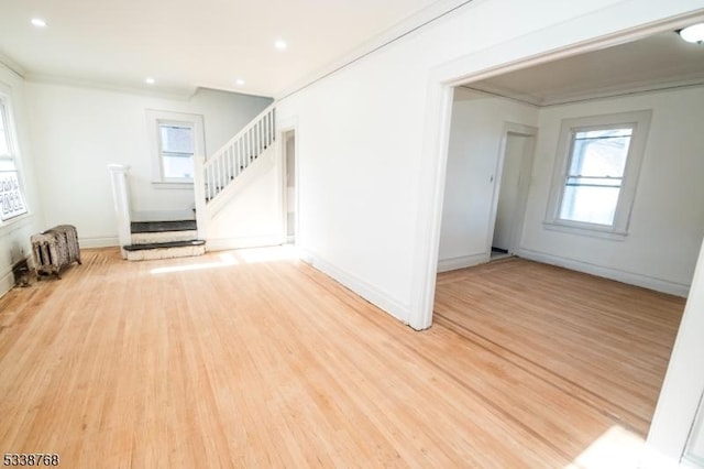 interior space featuring plenty of natural light, stairs, wood finished floors, and radiator
