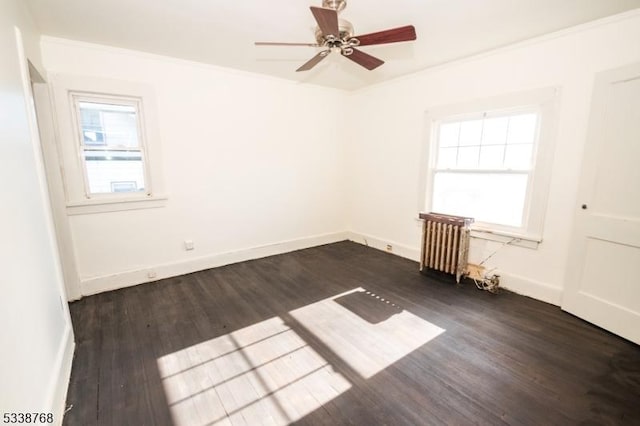unfurnished room featuring radiator, baseboards, dark wood-style floors, and ceiling fan