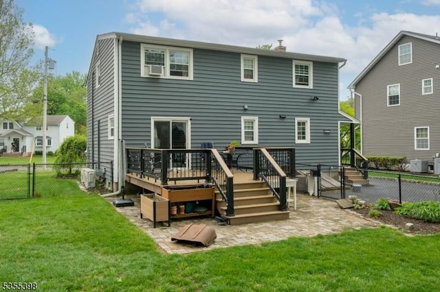 back of property featuring a deck, a chimney, a gate, and central air condition unit