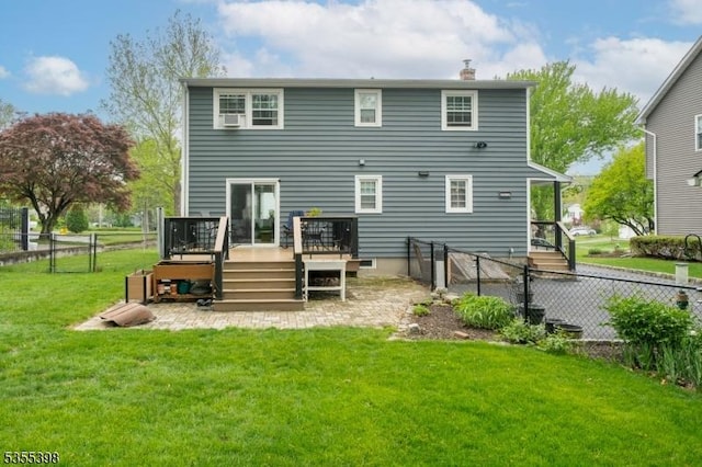 rear view of house with a wooden deck, a chimney, and a gate