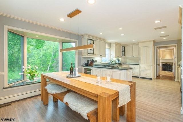 59 Green Hill Rd, Kinnelon Boro, NJ 07405 - dining room with crown molding, a baseboard radiator, light wood-type flooring, recessed lighting, and beverage cooler