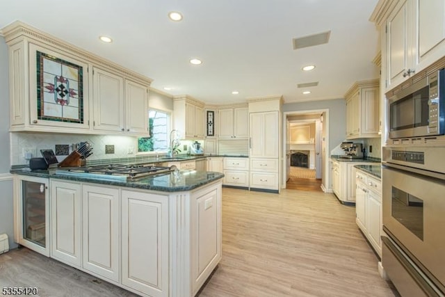 59 Green Hill Rd, Kinnelon Boro, NJ 07405 - kitchen featuring stainless steel appliances, cream cabinetry, recessed lighting, decorative backsplash, and a peninsula