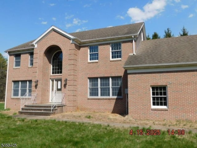 rear view of property featuring brick siding