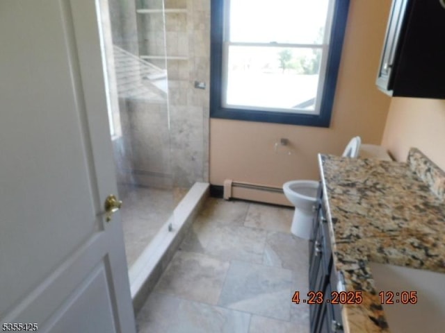 bathroom with vanity, a stall shower, a baseboard heating unit, and toilet