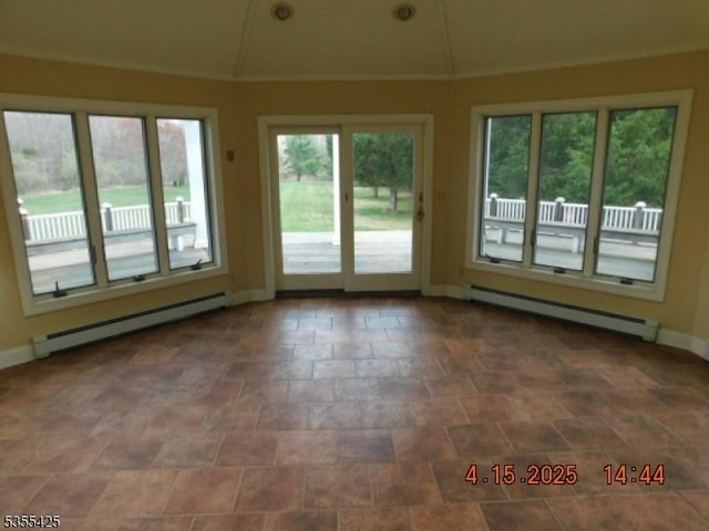 unfurnished sunroom featuring plenty of natural light and baseboard heating