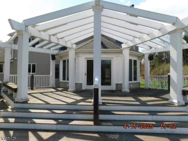 back of property featuring a pergola
