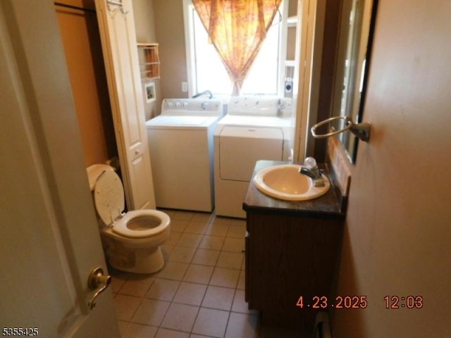 bathroom featuring separate washer and dryer, tile patterned flooring, toilet, and vanity