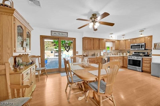 dining area featuring light wood-style floors and ceiling fan