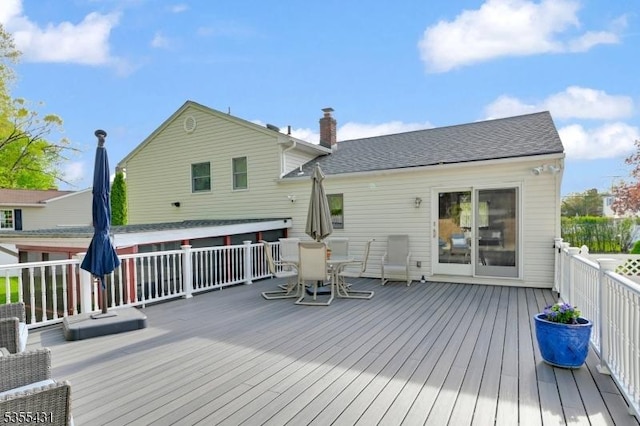 wooden terrace with outdoor dining space