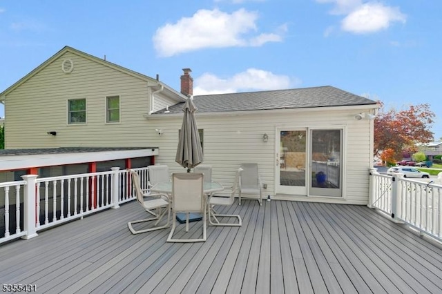 wooden terrace with outdoor dining area