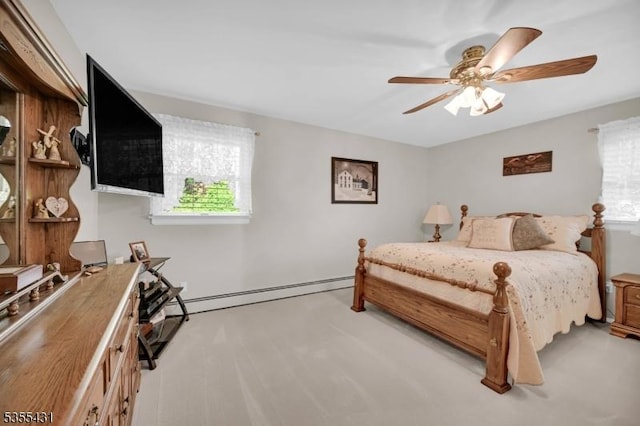 carpeted bedroom with multiple windows, ceiling fan, and a baseboard heating unit