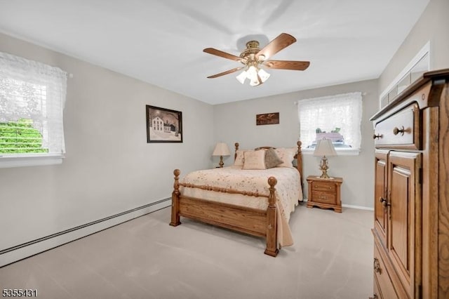 bedroom featuring light colored carpet, baseboard heating, baseboards, and ceiling fan