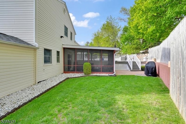 view of yard with a sunroom and a deck