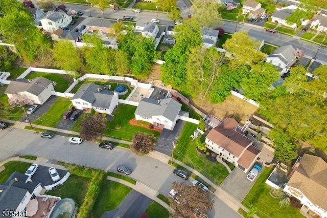 aerial view of property and surrounding area featuring nearby suburban area