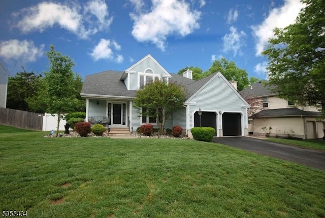 view of front of house featuring driveway, a garage, and a chimney