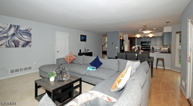living room with baseboards and light wood-style floors