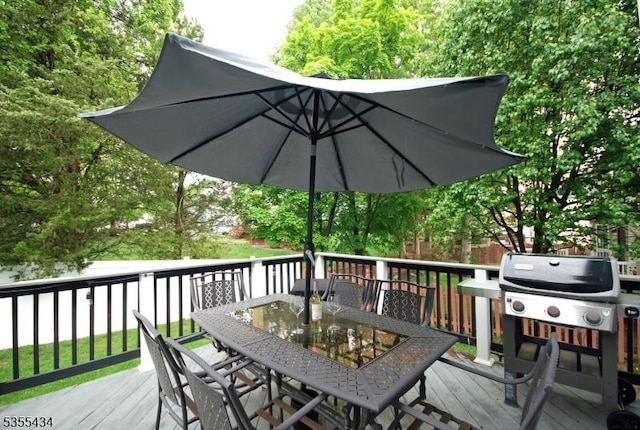 wooden deck with outdoor dining space and a grill