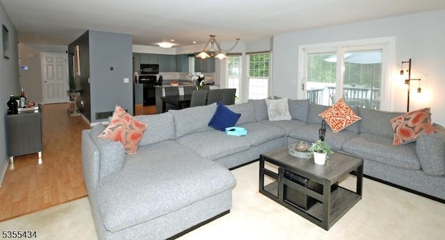 living room featuring light wood-style flooring and a chandelier