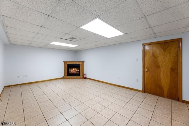 1296 Millstone River Rd, Hillsborough Twp, NJ 08844 - basement with a paneled ceiling, a warm lit fireplace, baseboards, and visible vents