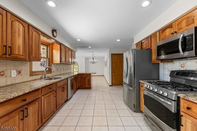 1296 Millstone River Rd, Hillsborough Twp, NJ 08844 - kitchen with stainless steel appliances, brown cabinets, light stone countertops, and a sink