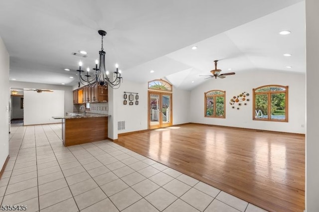 1296 Millstone River Rd, Hillsborough Twp, NJ 08844 - kitchen with lofted ceiling, open floor plan, light tile patterned flooring, and ceiling fan with notable chandelier