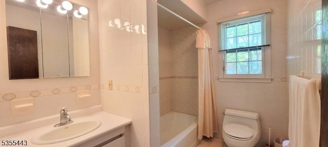 bathroom featuring vanity, shower / bath combo, and toilet