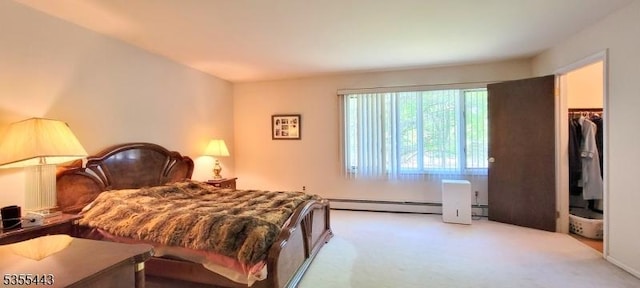 carpeted bedroom with a baseboard heating unit