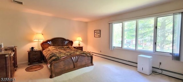 carpeted bedroom featuring baseboard heating