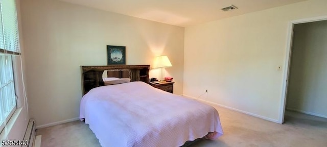 bedroom featuring light colored carpet, baseboard heating, and baseboards