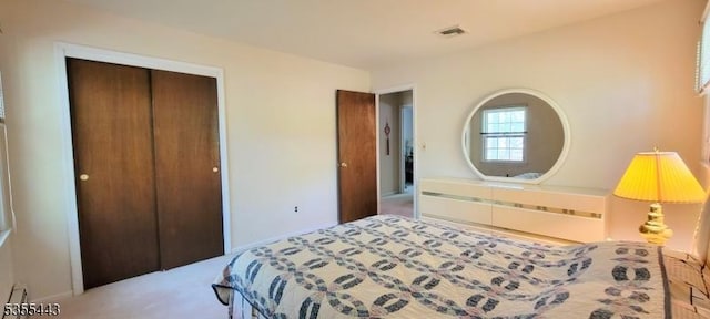 carpeted bedroom featuring a closet