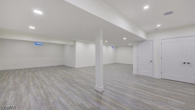 finished basement with light wood-style floors, baseboards, and recessed lighting