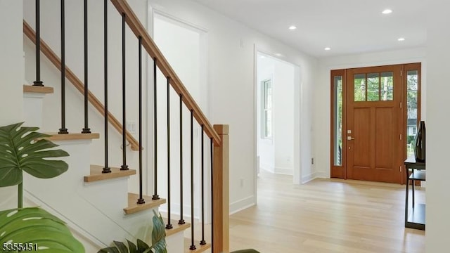 entryway featuring light wood-style floors, stairs, recessed lighting, and baseboards