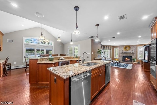 kitchen with visible vents, a sink, a large island, and dishwasher