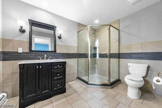 full bath with tile patterned flooring, toilet, tile walls, a shower stall, and a baseboard radiator