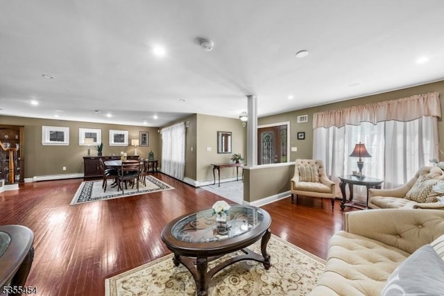 living area featuring recessed lighting, baseboards, wood finished floors, and a baseboard radiator