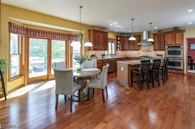 dining area with wood finished floors and recessed lighting