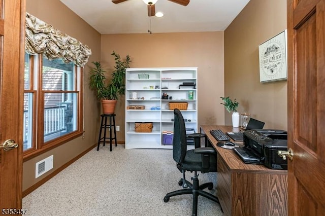 carpeted office with baseboards, ceiling fan, and visible vents