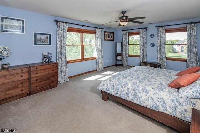 bedroom featuring ceiling fan, carpet, baseboards, and visible vents
