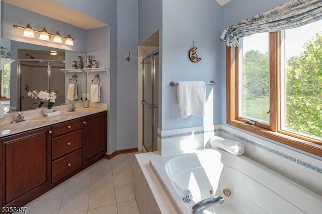 full bath featuring a sink, a stall shower, and a healthy amount of sunlight