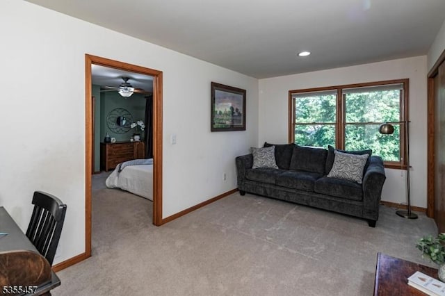 living area featuring light carpet, baseboards, ceiling fan, and recessed lighting