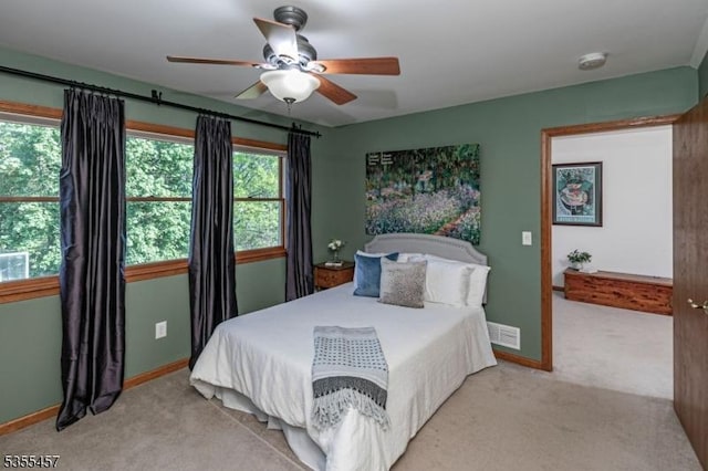 bedroom with light carpet, baseboards, and ceiling fan