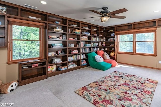 sitting room with a wealth of natural light, carpet floors, visible vents, and recessed lighting