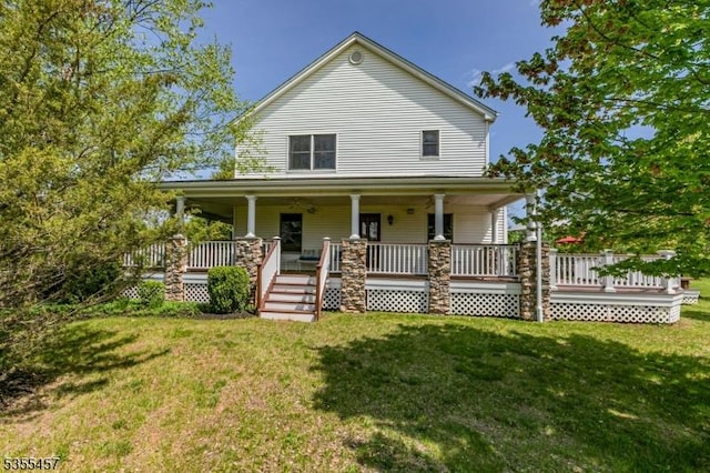 farmhouse with covered porch and a front lawn