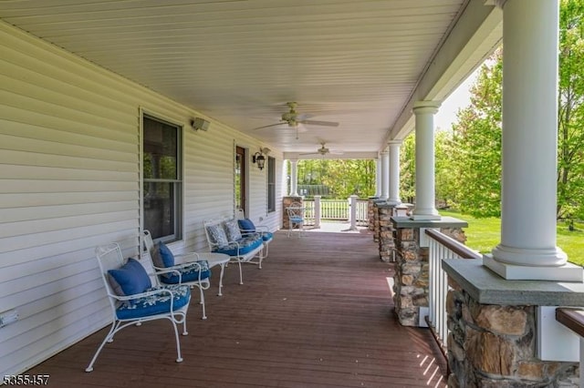 wooden deck featuring covered porch and ceiling fan
