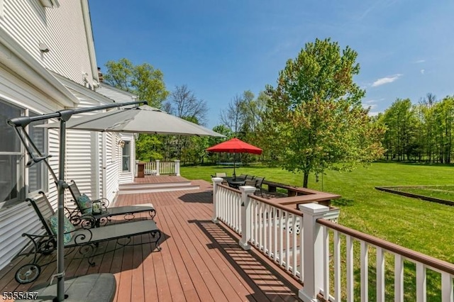 wooden terrace featuring a yard