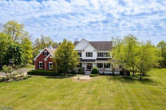 view of front facade with a front yard and covered porch