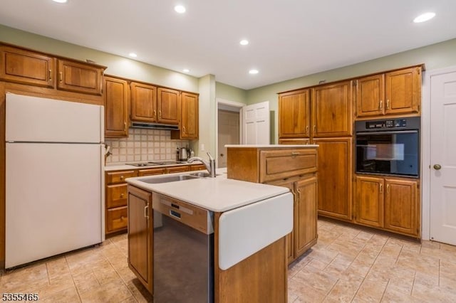 1178 Delaware Dr, Bridgewater Twp, NJ 08807 - kitchen with freestanding refrigerator, black oven, a sink, a kitchen island with sink, and brown cabinets
