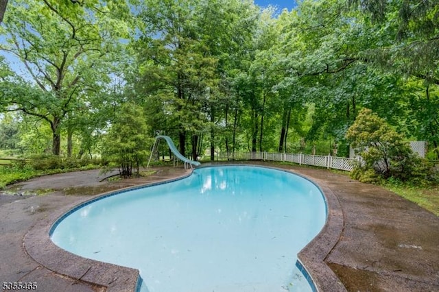 1178 Delaware Dr, Bridgewater Twp, NJ 08807 - view of pool with a water slide, fence, and view of scattered trees
