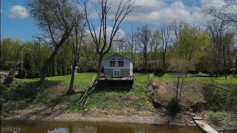 1 Lenape Ln, Harmony Twp, NJ 08865 - view of grassy yard with stairs and a water view